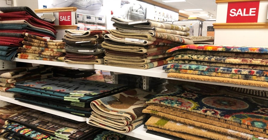 lots of different doormats on store display shelves