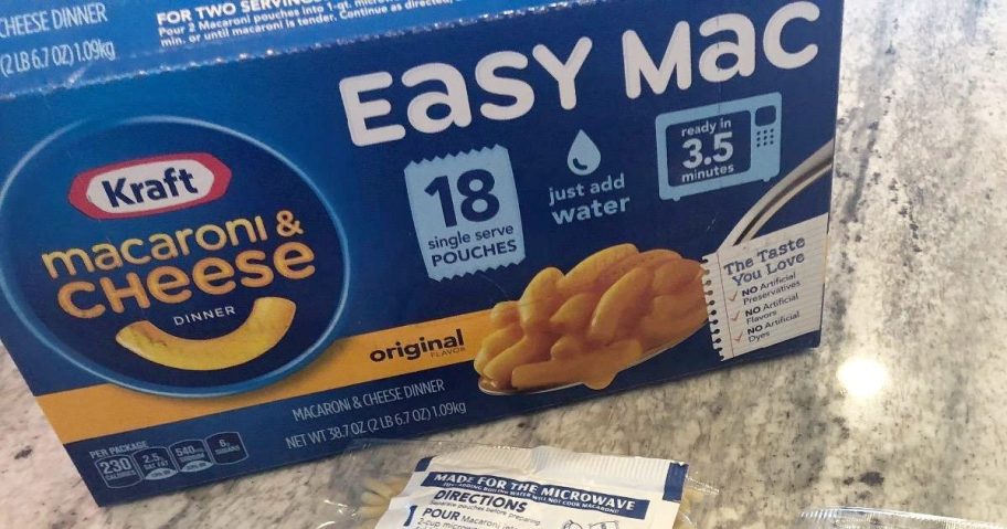 blue box of kraft easy mac packets with packets of dry pasta on kitchen counter