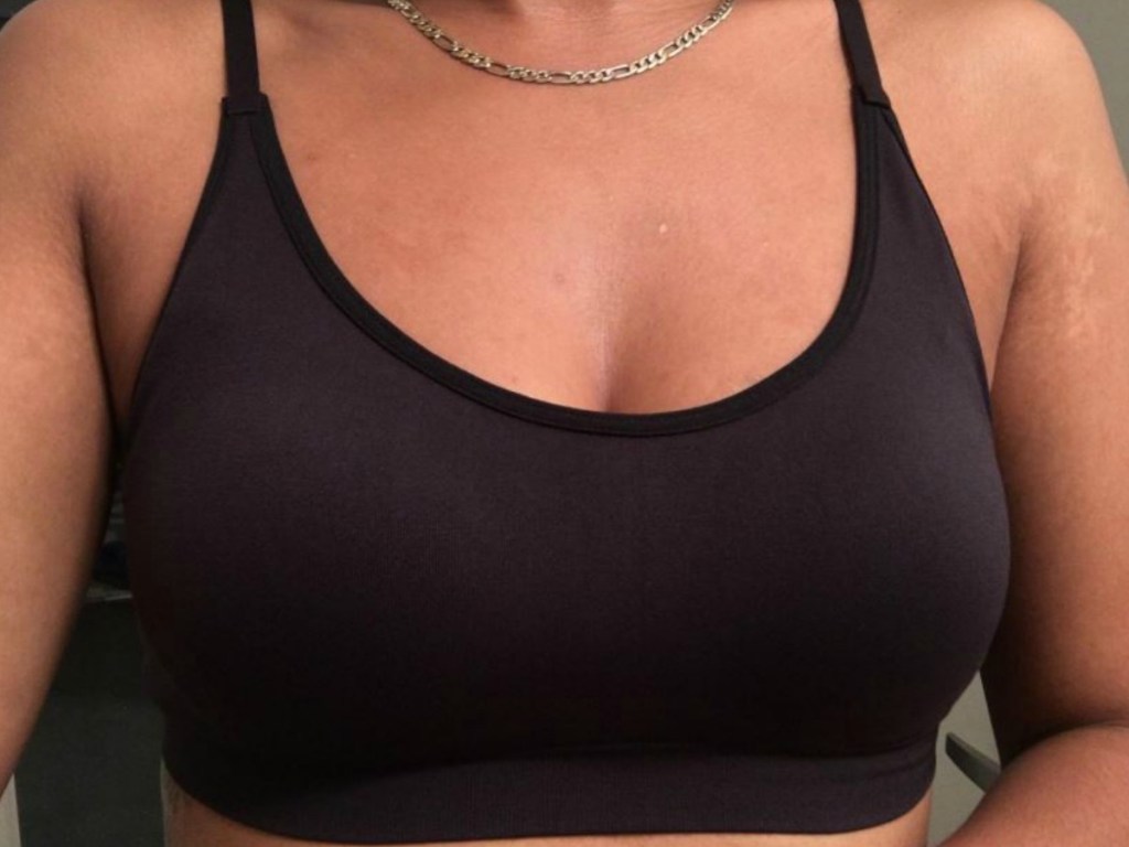 Woman's torso with black sports bra on