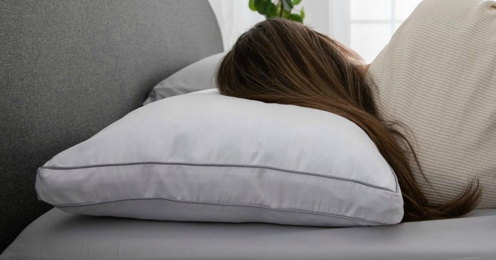 Woman lying on Mattress Firm Sleepy's Comfy Pillow