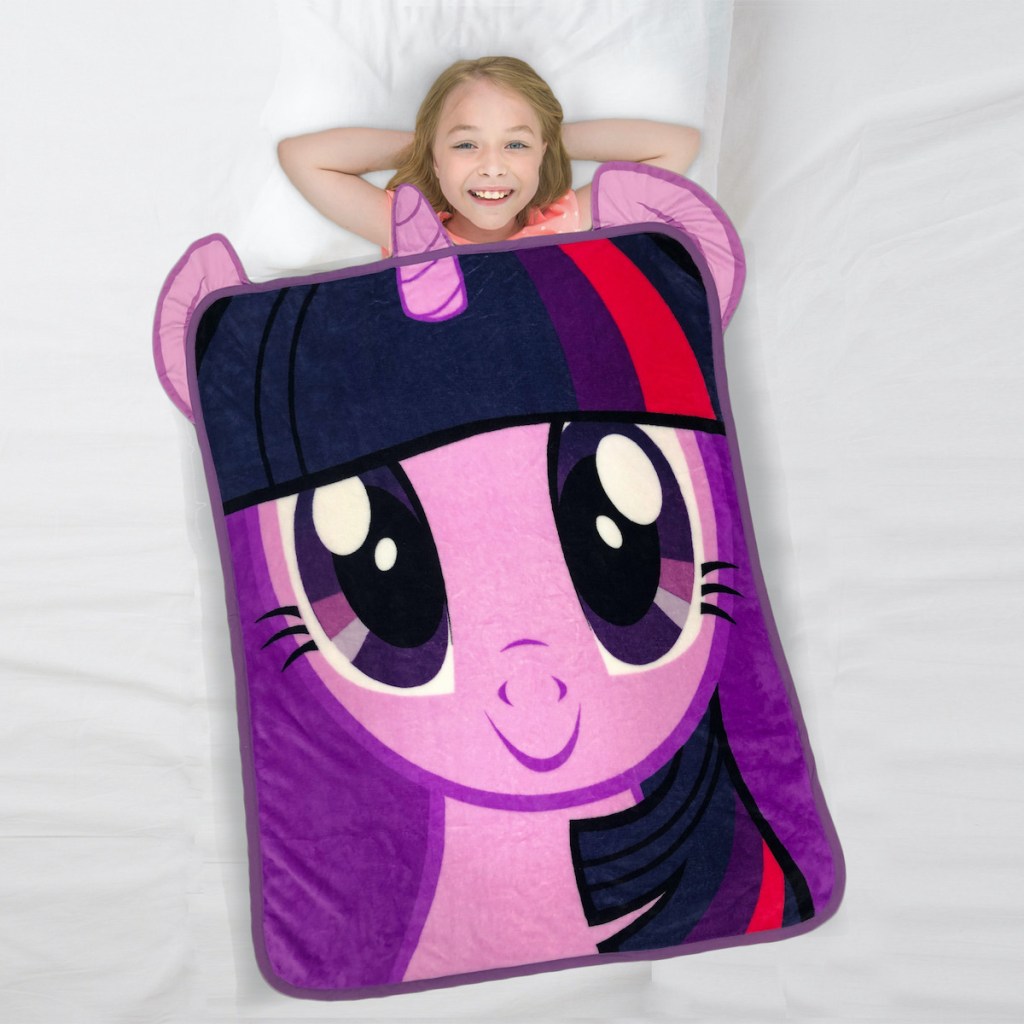 girl laying in bed with My Little Pony Kids Throw