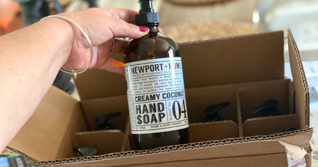 Person pulling out Newport Hand Soap from box