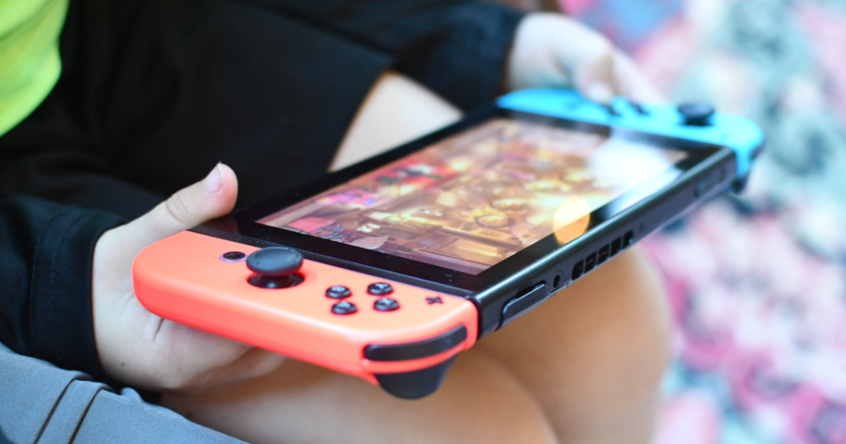 two kids using handheld game console