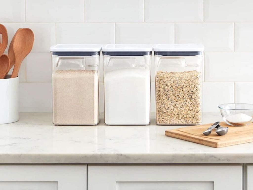 three large food storage containers on counter top