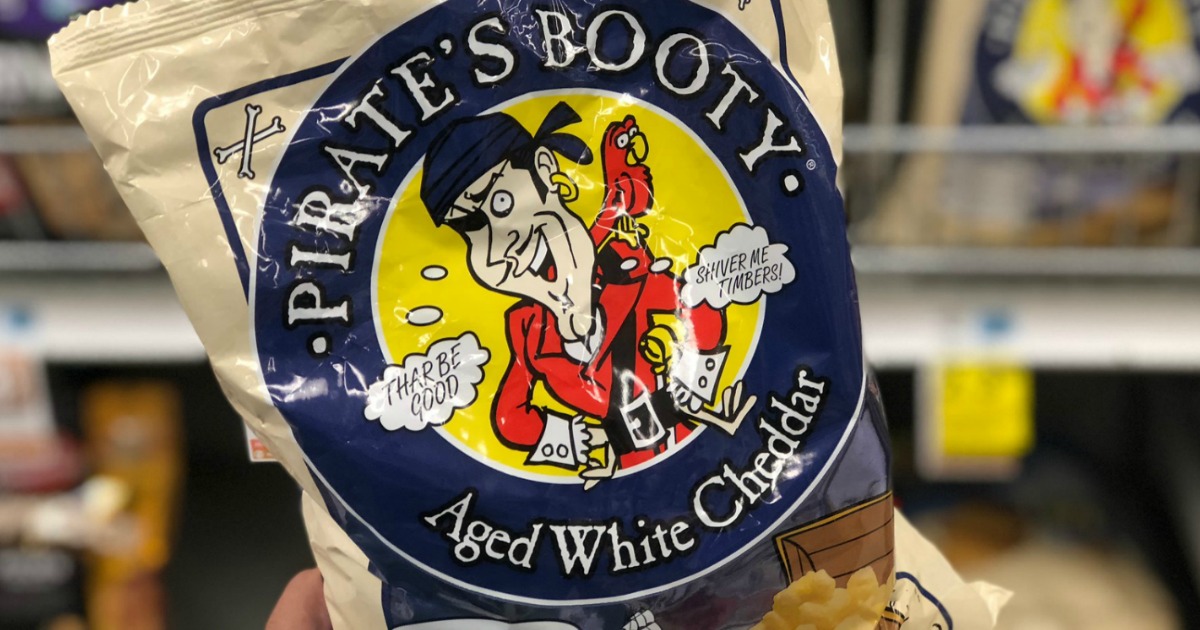 Hand holding large back of white cheddar puff snacks in-store