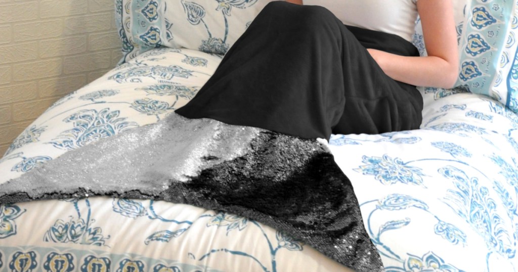 girl on bed in black mermaid sequin throw blanket