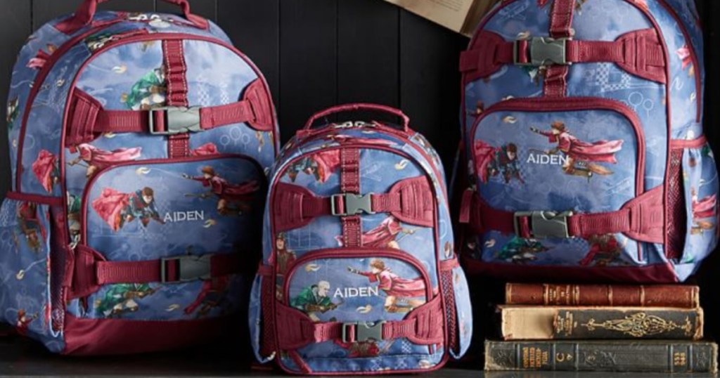three harry potter themed backpacks sitting next to each other and a stack of books