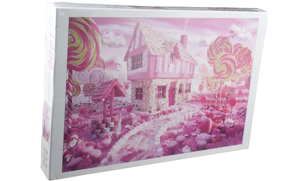 puzzle box with a photo of a pink house and yard made out of candy