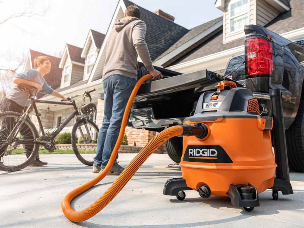 Guy cleaning back of truck with RIDGID shop/vac