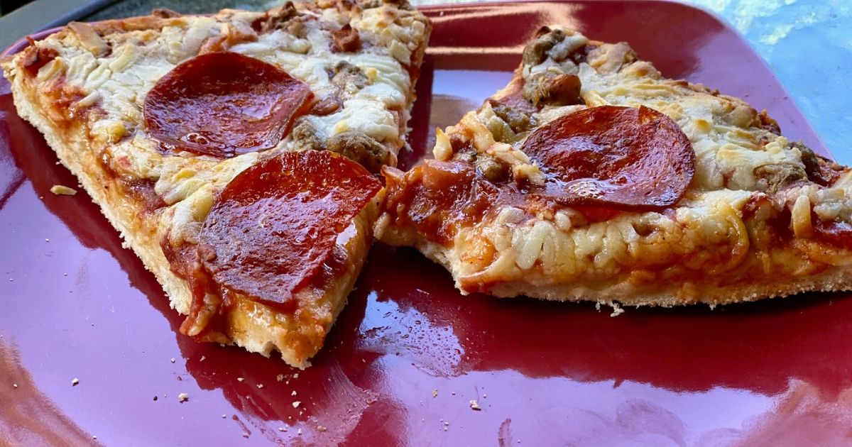 Two slices of Red Baron 4 meat pizza on a plate
