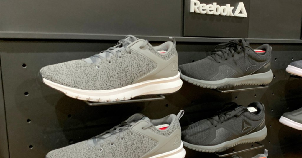 store display of reebok brand shoes in grey and black mesh styles