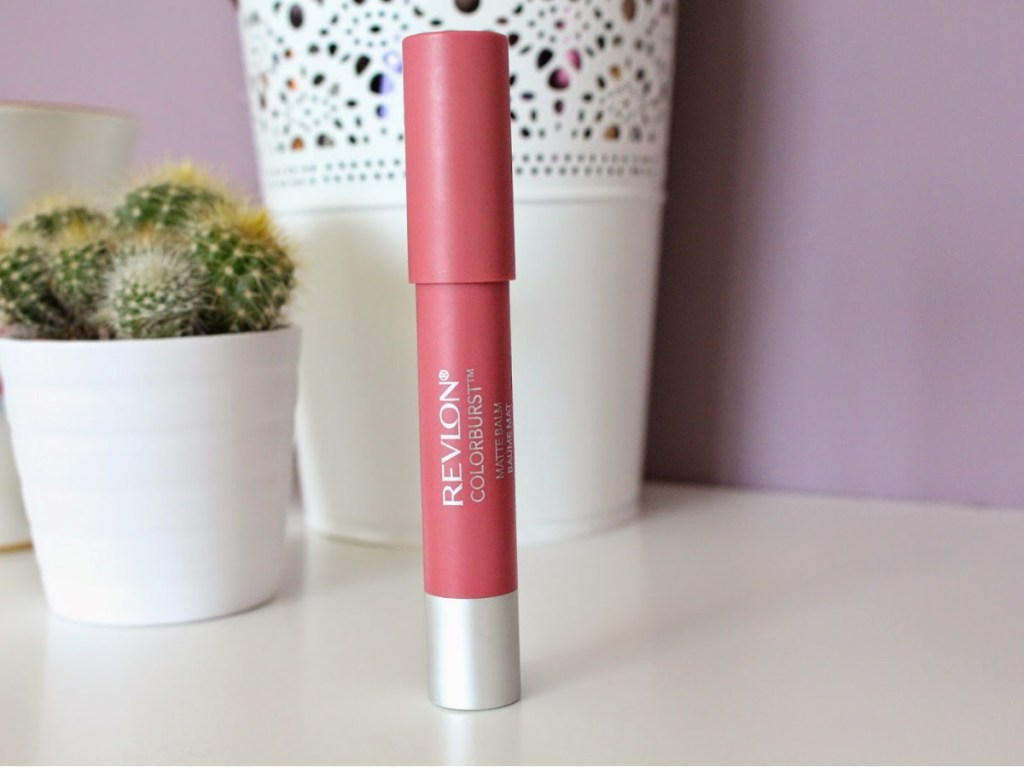 light pink lip balm standing on counter with small cactus in background