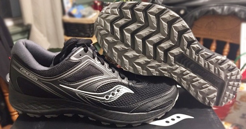 pair of black and grey running shoes with rugged rubber sole