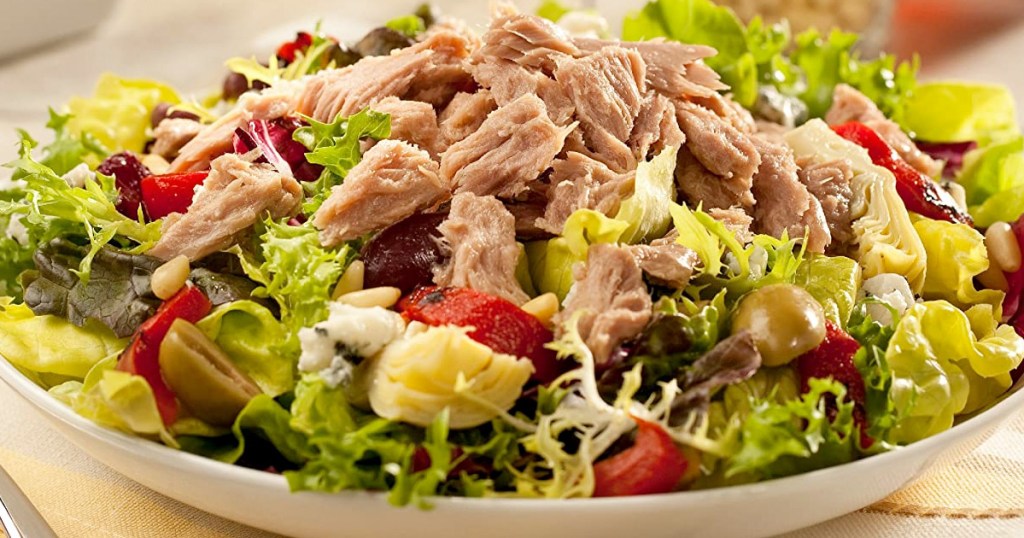 bowl of salad topped with shredded tuna