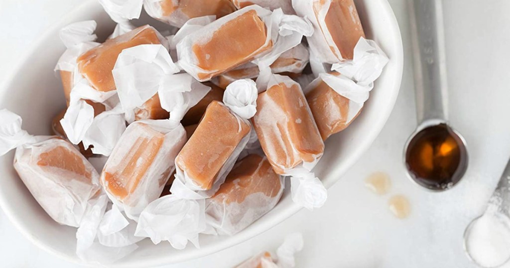 bowl of caramels with a measuring spoon next to it