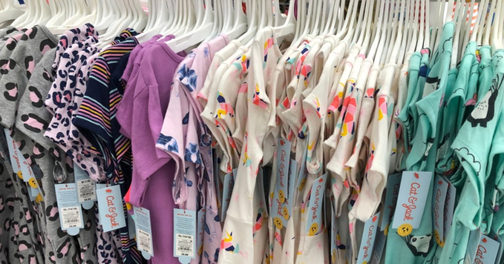 various girls dresses hanging on store rack