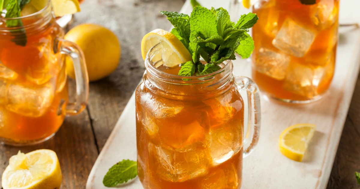 iced Tetley tea with mint sprigs and lemon wedges in mason jars