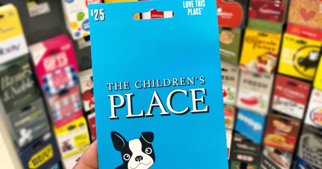person holding up blue $25 childrens place gift card