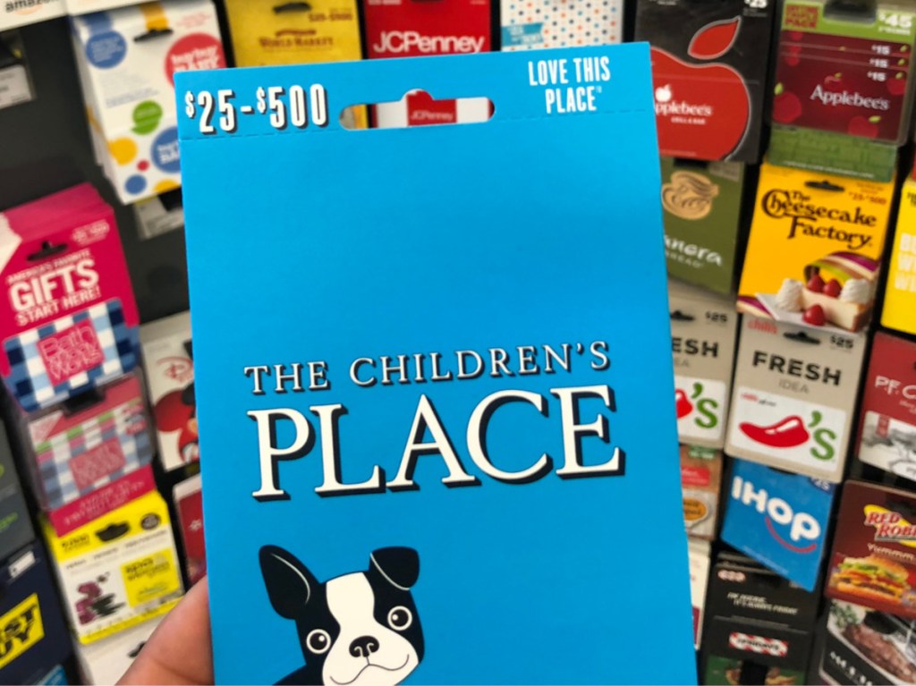The Children's Place gift card in front of display of gift cards