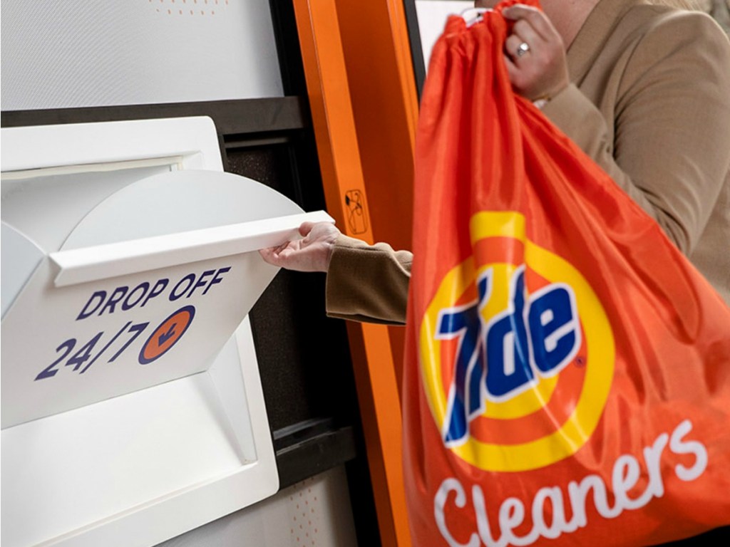 Woman dropping off laundry in Tide bag