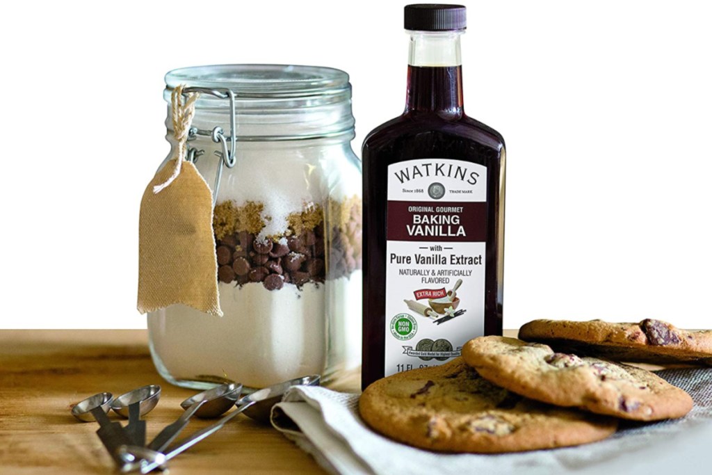 watkins original vanilla extract next to cookie jar and cookies on counter