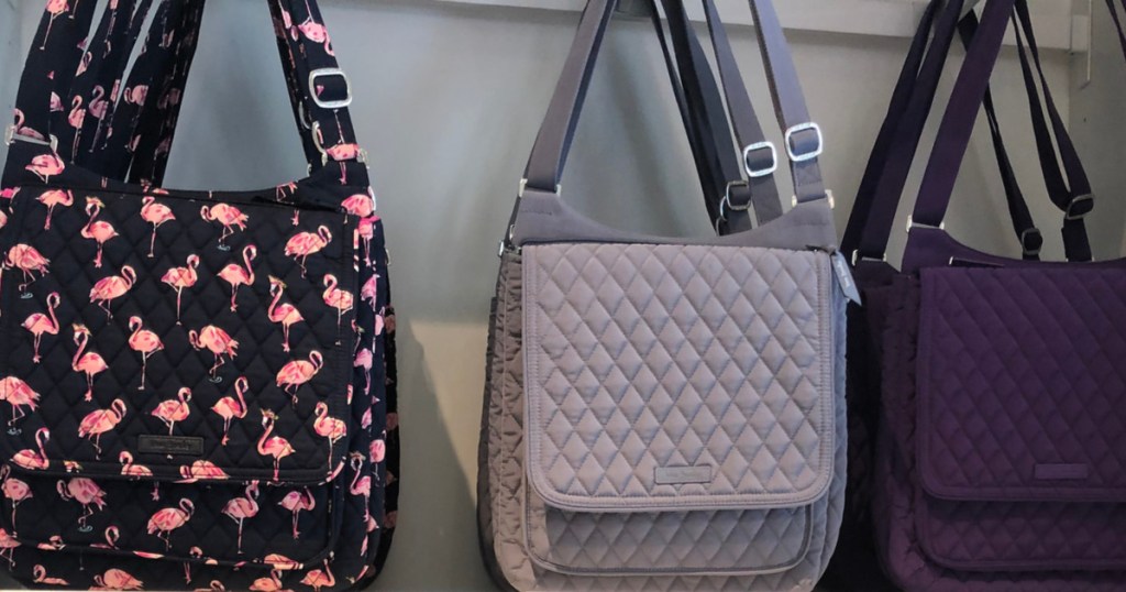 black flamingo bag, grey bag, and purple bag hanging in store