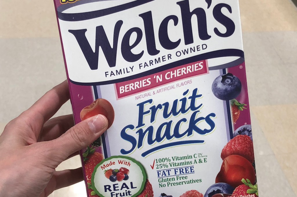 hand holding box of fruit snacks