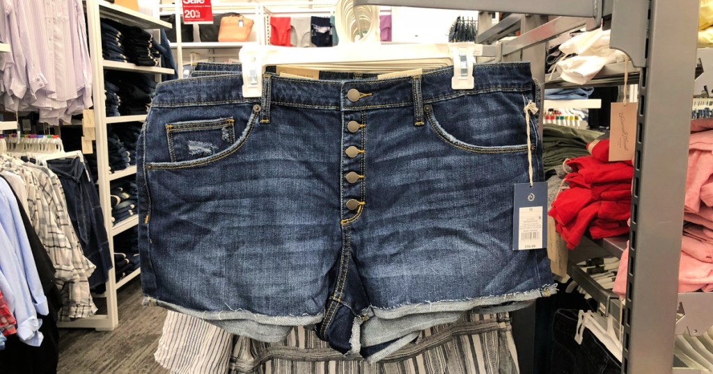 women's jean shorts with multiple buttons handing on clothing rack at Target