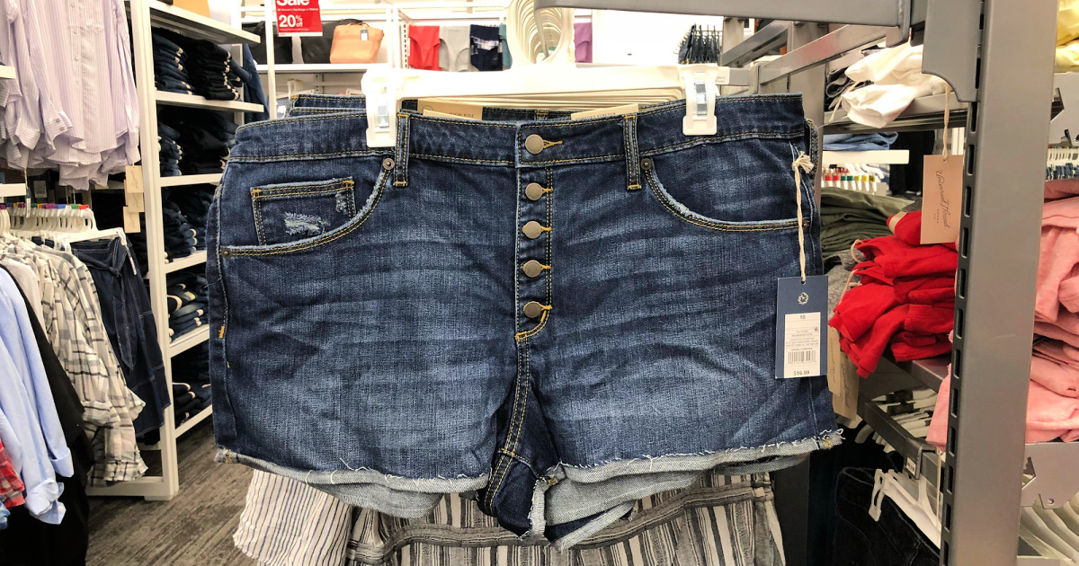 women's jean shorts with multiple buttons handing on clothing rack at Target