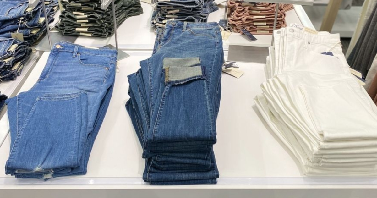light wash, dark wash, and white women's jeans on display table at target