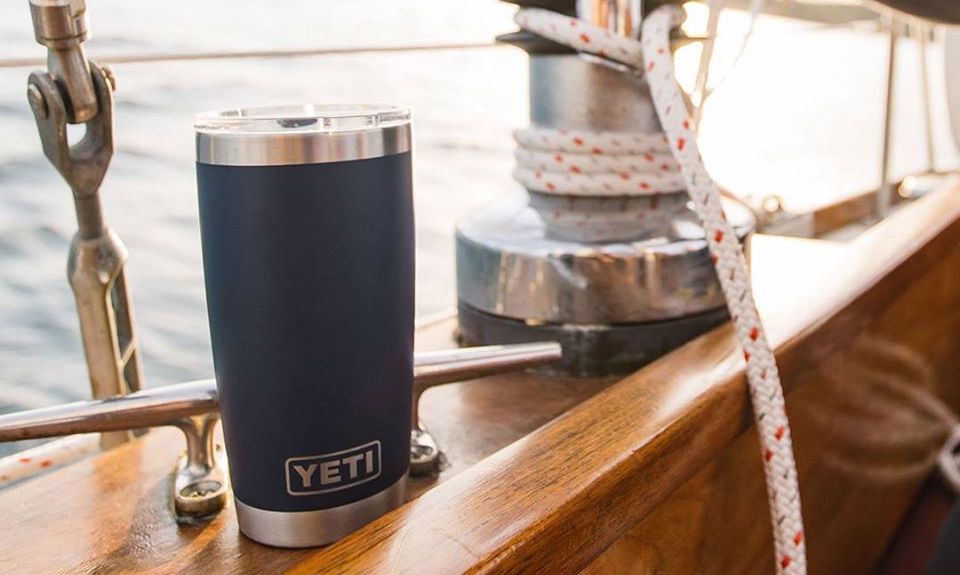 YETI tumbler sitting on the side of a boat