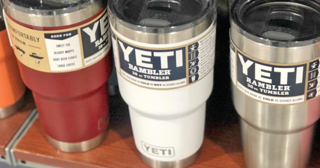 store display shelf of red, white, and stainless steel yeti tumblers