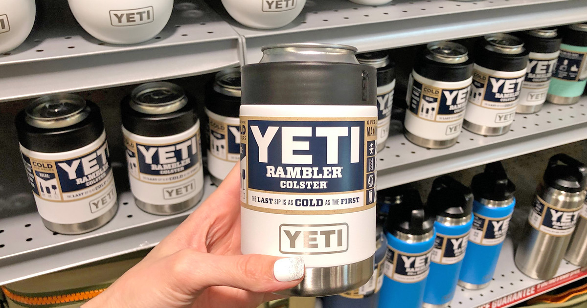 person holding up a white yeti brand can insulator