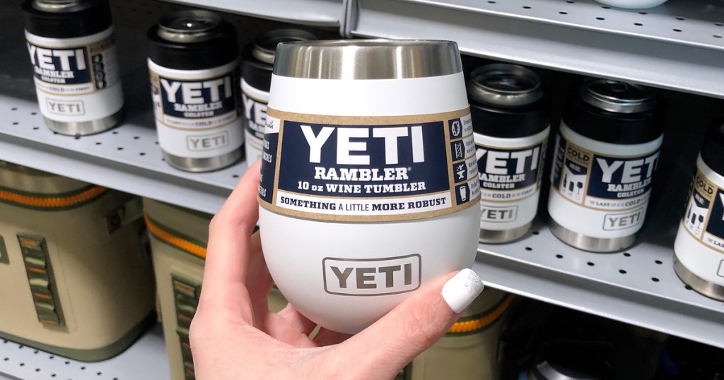 person holding up a white yeti brand wine tumbler