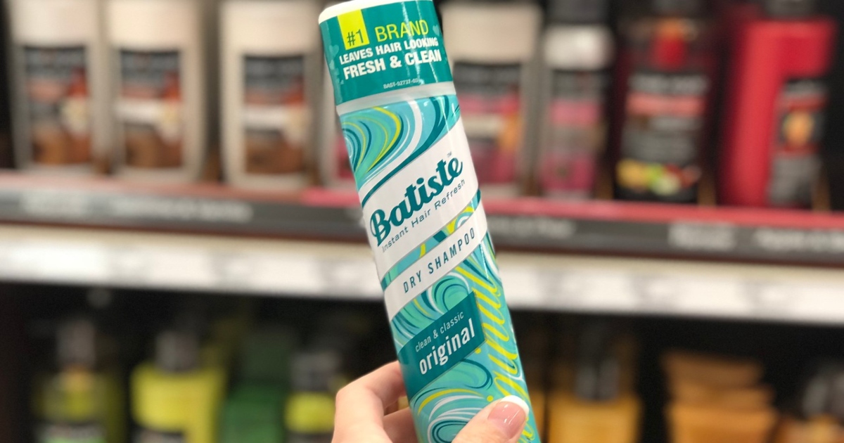 Batiste original dry shampoo, held by a ladies hand, in front of store shelves