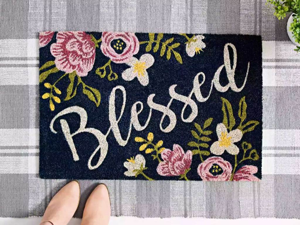 doormat with word blessed on it and flowers