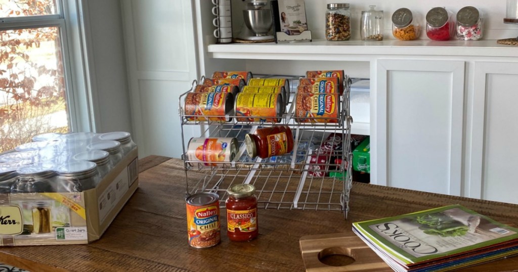 various cans of food on stainless steel wire rack sitting on island in large pantry