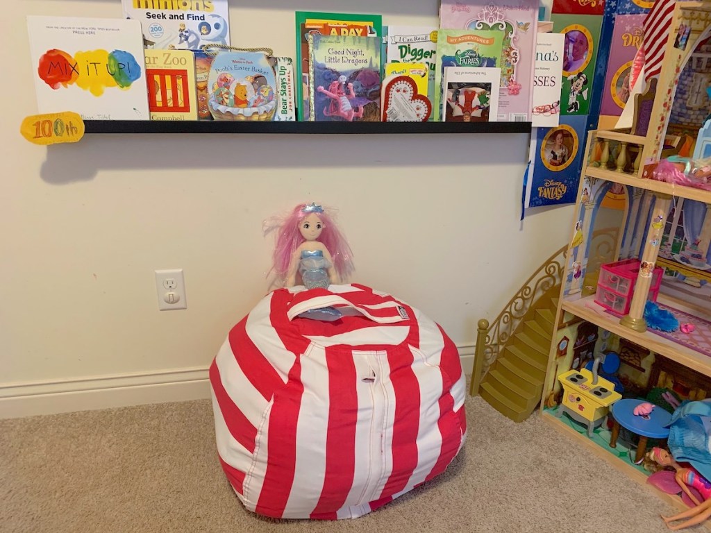 clean kids room with hot pink and white stripe bean bag chair and various kids books