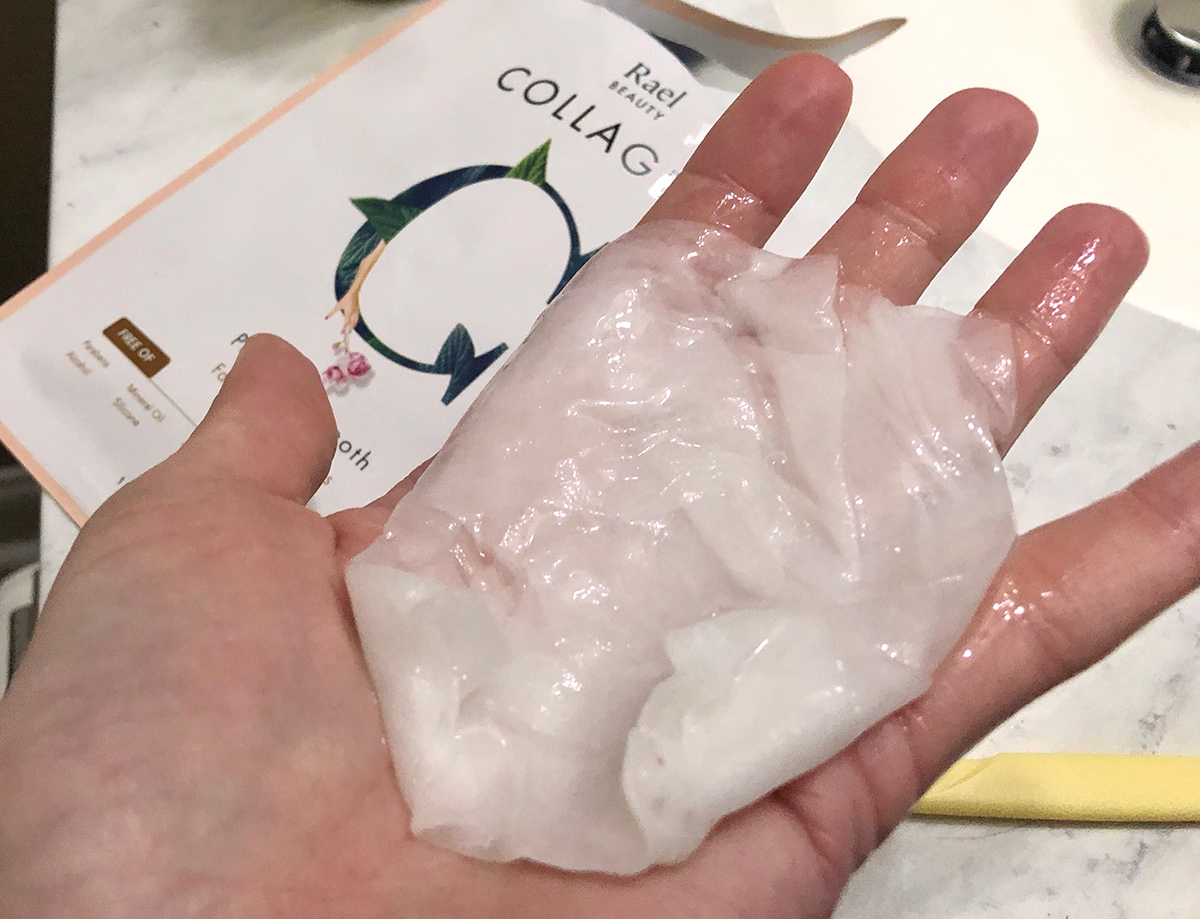 hand holding sheet mask loaded with collagen serum