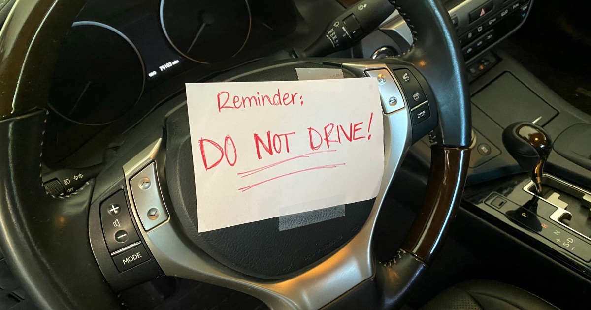 do not drive sign taped to steering wheel