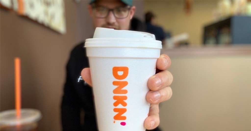 man holding dunkin donuts cup
