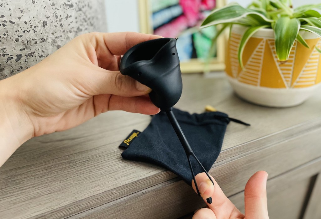 finger pulling down on menstrual cup