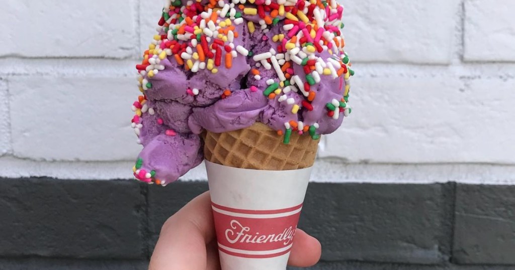 holding an ice cream cone with sprinkles