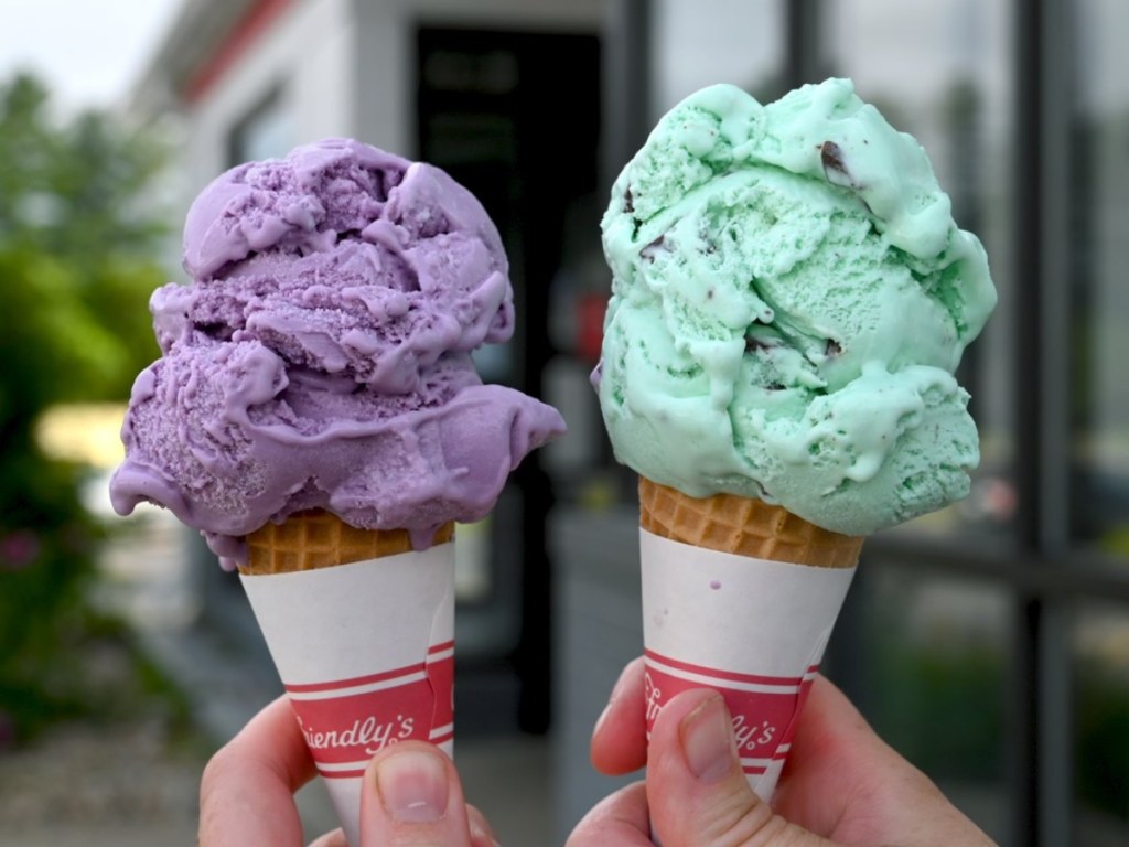 holding 2 ice cream cones