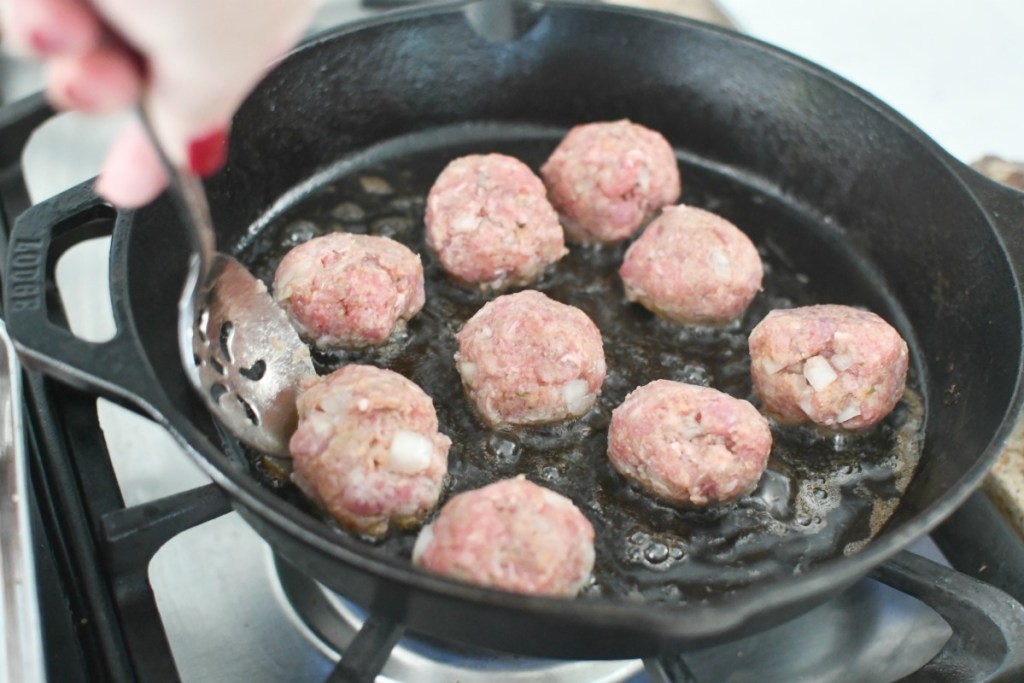 frying meatballs in a cast iron pan