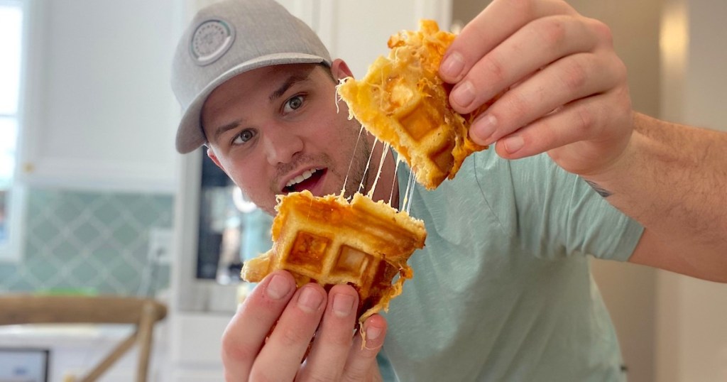 man holding a waffle shaped grilled cheese