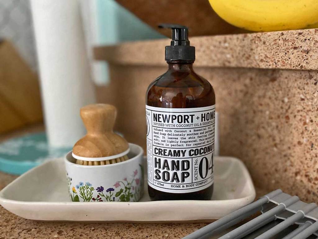 bottle of soap sitting on a dish