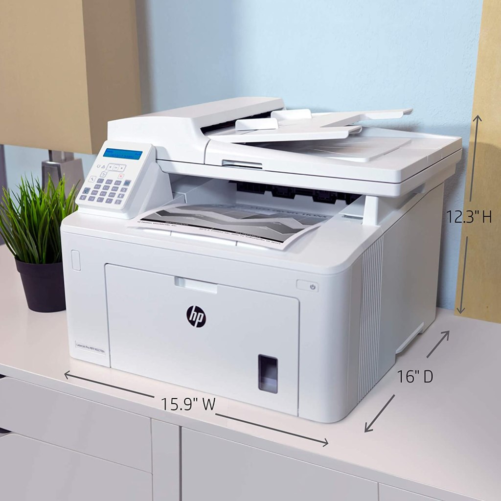 white hp laser printer on office cabinet with plant beside it