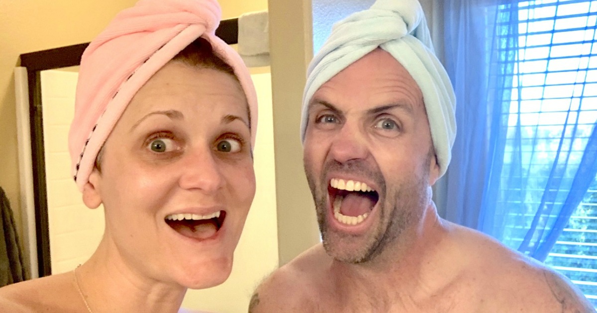 woman and man with hair towels on their heads 