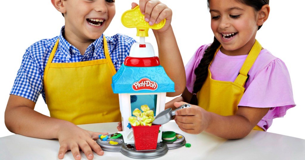 kids playing with a Play-Doh Kitchen Creations Popcorn Party Play Food Set